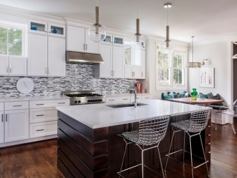 Kitchen interior with island, sink, cabinets, hardwood floors in luxury home. Raleigh, North Carolina